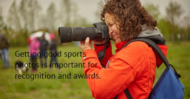 an amateur photographer takes photos at a sporting event.